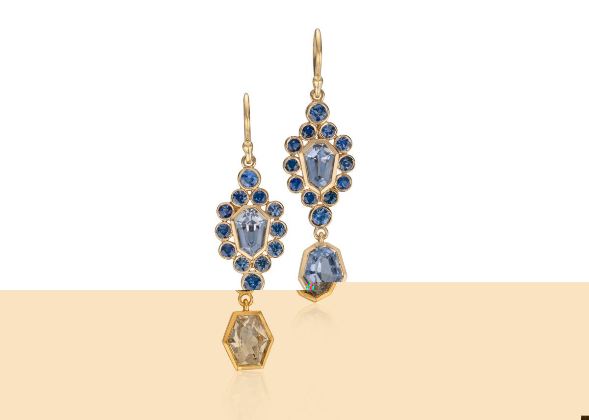 pair of one of a kind sapphire earrings on white background