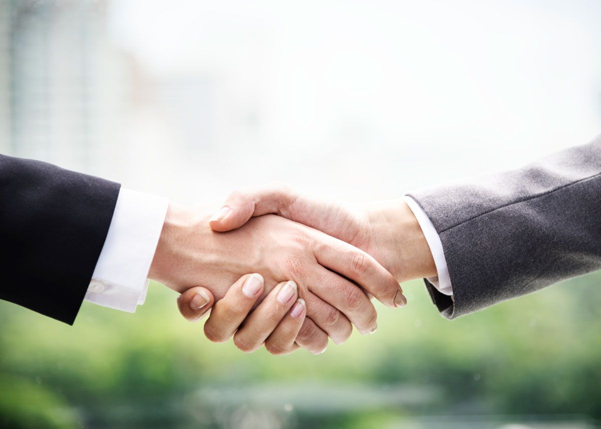 close up of two business people shaking hands
