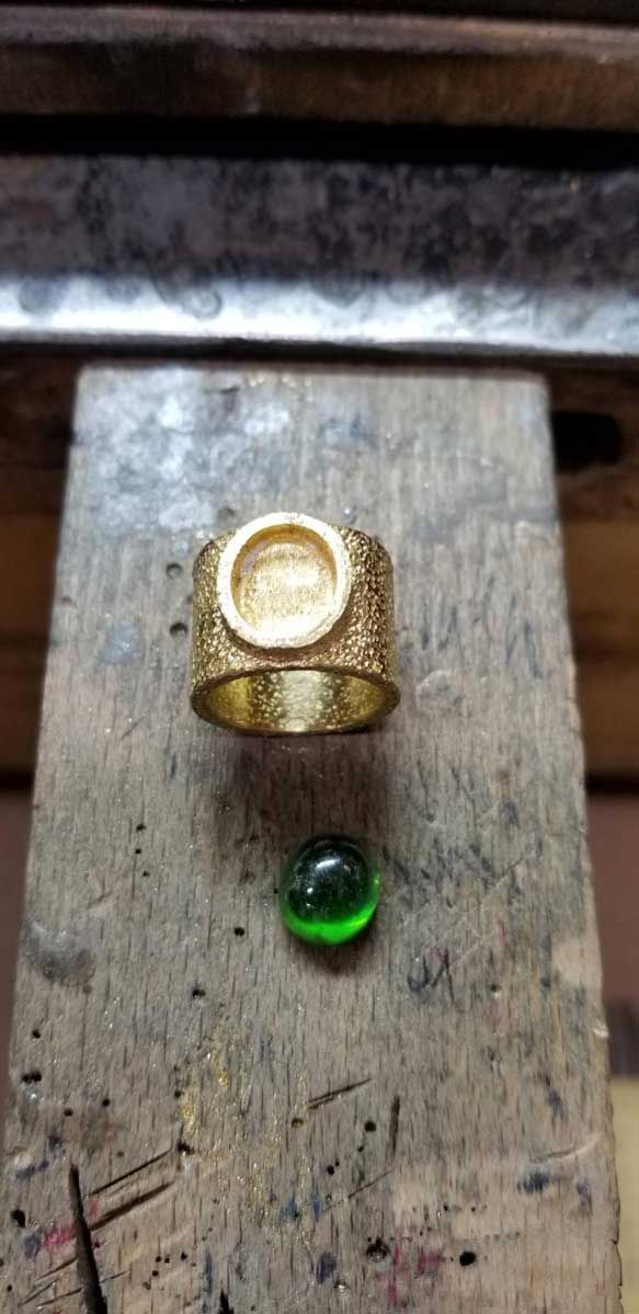 22kt gold setting for a rare Cat's Eye demantoid garnet.