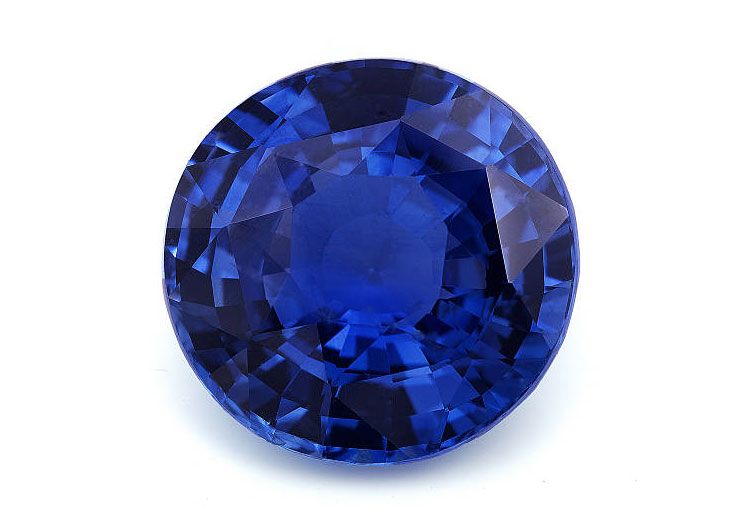 Round blue sapphire on white background