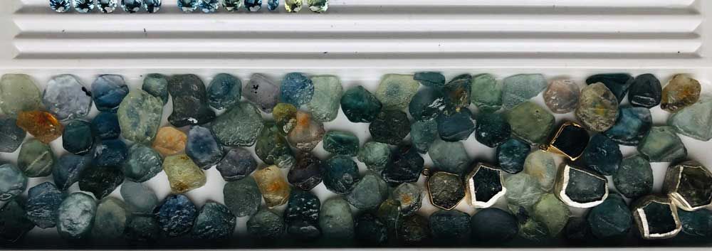 Palette of green rough gemstones